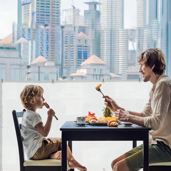 Father and son warmly having dinner together on the balcony covered by the balcony fence screen.